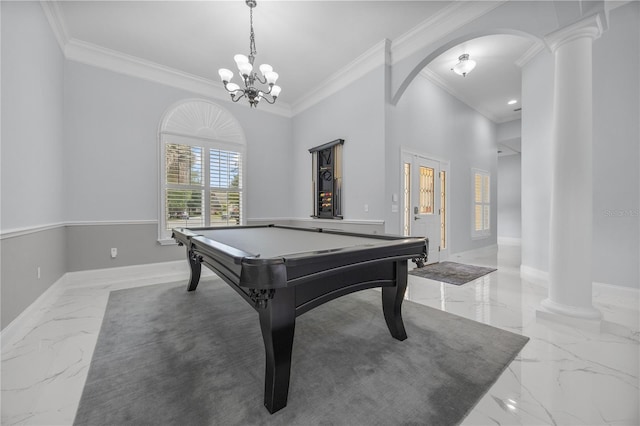 game room featuring arched walkways, marble finish floor, ornamental molding, and baseboards