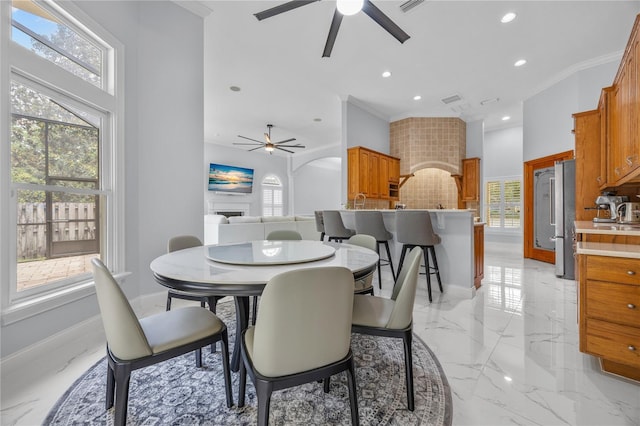 dining area featuring marble finish floor, baseboards, and a wealth of natural light