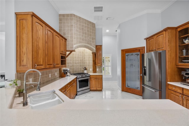 kitchen with visible vents, crown molding, appliances with stainless steel finishes, and a sink