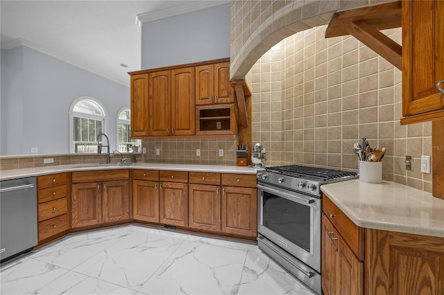 kitchen featuring brown cabinetry, ornamental molding, marble finish floor, stainless steel appliances, and a sink