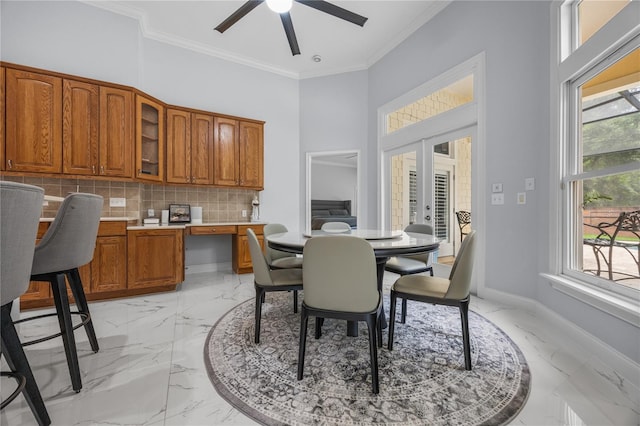 dining area with marble finish floor, baseboards, crown molding, and french doors