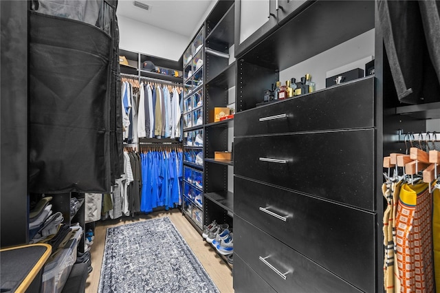 spacious closet featuring visible vents and wood finished floors