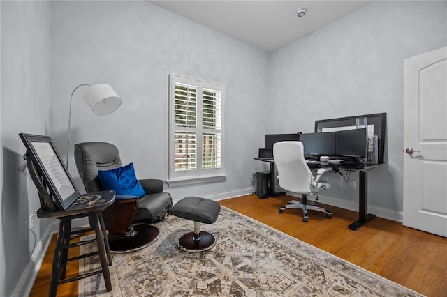 office space featuring baseboards and wood finished floors