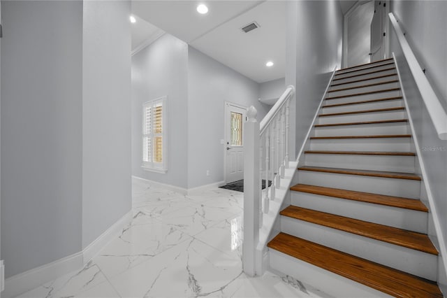 staircase featuring marble finish floor, baseboards, visible vents, and recessed lighting