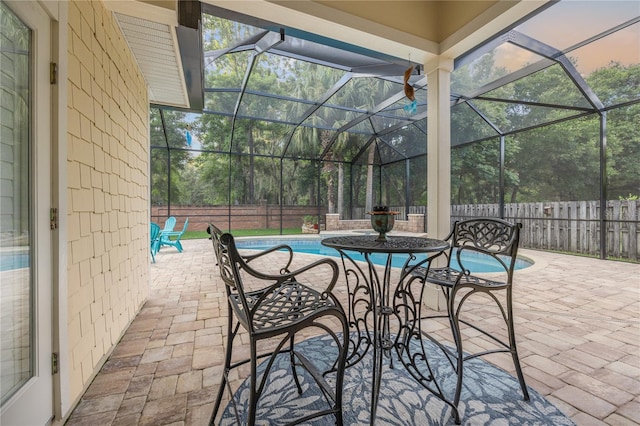 view of patio / terrace with a fenced in pool, glass enclosure, and a fenced backyard