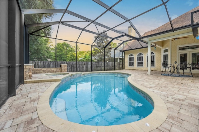 view of pool featuring a patio, ceiling fan, a lanai, fence, and a pool with connected hot tub