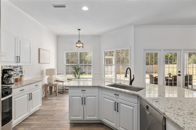 kitchen featuring dishwasher, stove, a sink, and crown molding