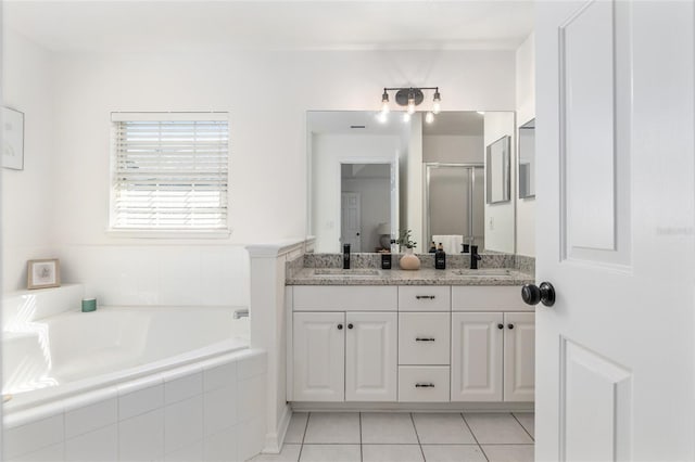 full bath featuring double vanity, a shower stall, a sink, and a bath