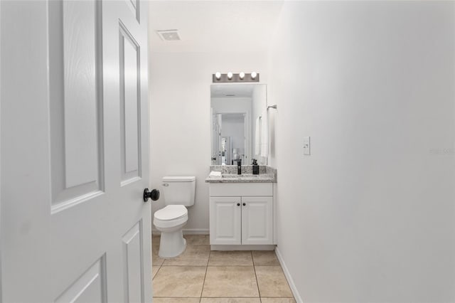 bathroom with baseboards, visible vents, toilet, tile patterned floors, and vanity