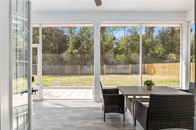 sunroom / solarium featuring ceiling fan