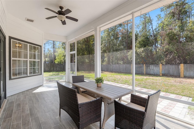 unfurnished sunroom with ceiling fan and visible vents