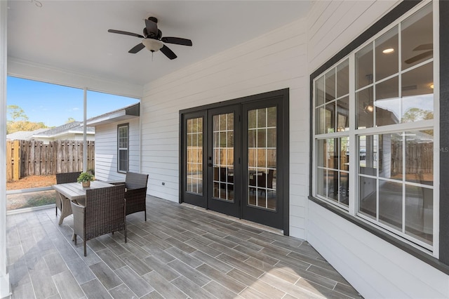 sunroom featuring a ceiling fan