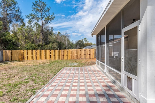 view of patio / terrace with fence private yard and a sunroom