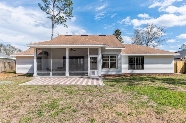 back of house featuring a sunroom, a patio area, fence, and a lawn