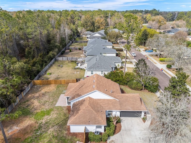 birds eye view of property featuring a view of trees