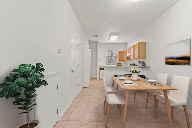 dining space featuring light tile patterned flooring, visible vents, and baseboards