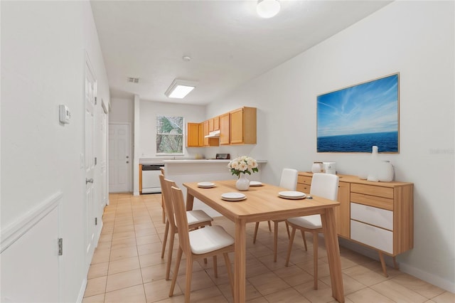 dining space with light tile patterned floors, visible vents, and baseboards