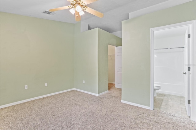 unfurnished bedroom with baseboards, visible vents, a spacious closet, carpet floors, and a closet