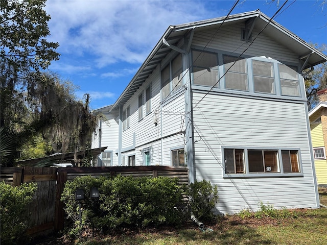 view of side of home featuring fence