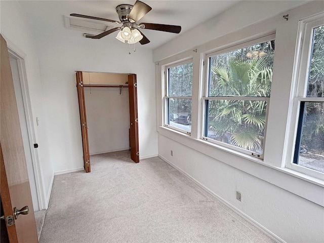 unfurnished bedroom with a closet, carpet, a ceiling fan, and baseboards