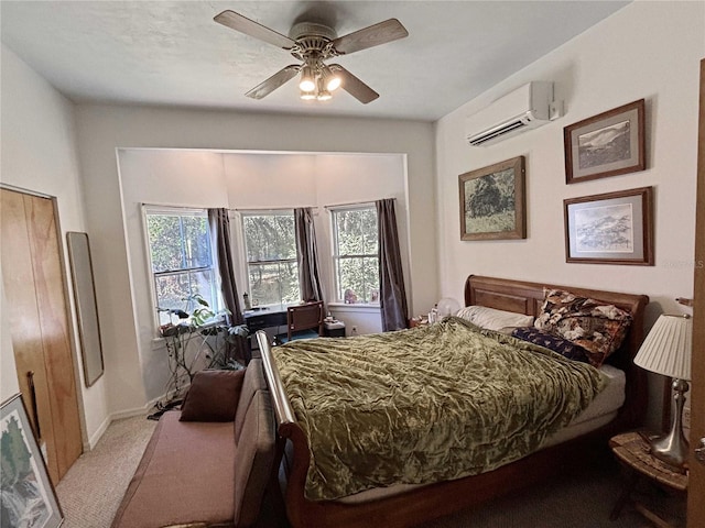 bedroom with baseboards, a wall unit AC, ceiling fan, and carpet flooring