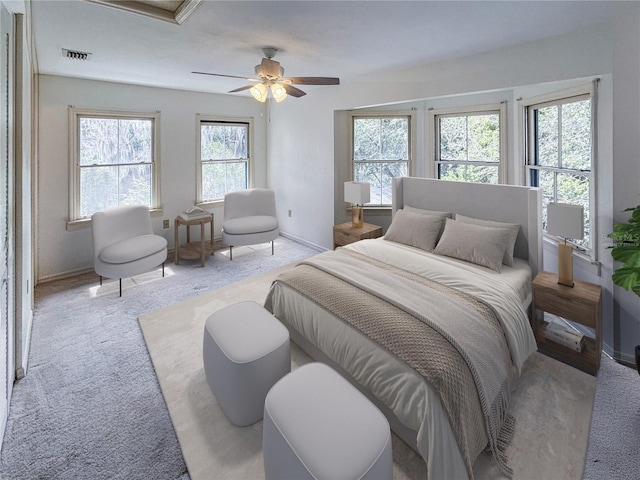 bedroom with light colored carpet, visible vents, and ceiling fan