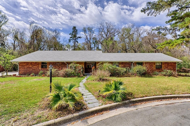 single story home with brick siding and a front yard