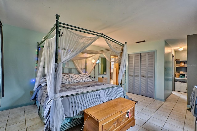 bedroom with light tile patterned floors and a closet