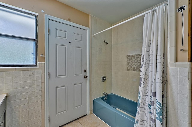 full bath featuring tile patterned flooring, shower / bath combo with shower curtain, and tile walls