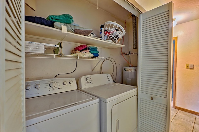 laundry room with laundry area, baseboards, electric water heater, separate washer and dryer, and light tile patterned flooring