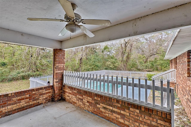 view of patio / terrace featuring ceiling fan, fence, and a fenced in pool