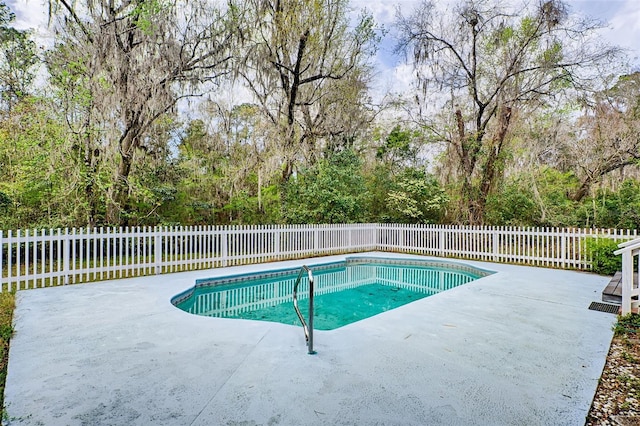 view of swimming pool featuring a patio area, a fenced backyard, and a fenced in pool