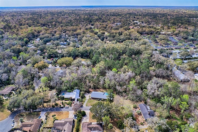 birds eye view of property featuring a wooded view