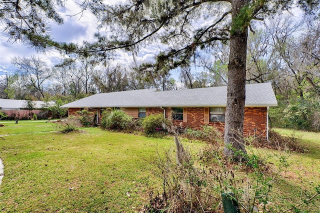 ranch-style home with brick siding and a front yard