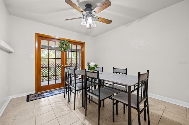 dining area featuring french doors, light tile patterned flooring, ceiling fan, and baseboards