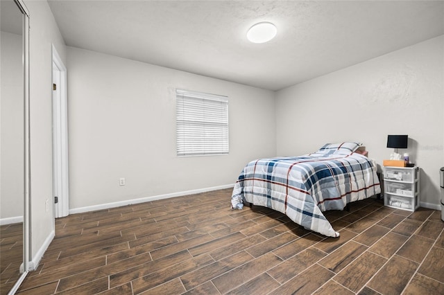 bedroom with wood tiled floor and baseboards