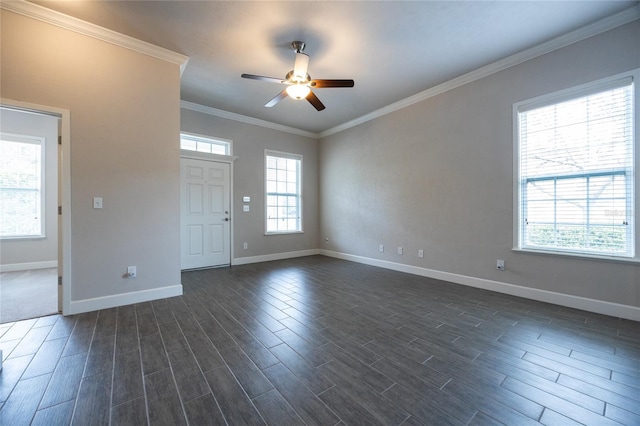 interior space with baseboards, ornamental molding, dark wood finished floors, and a ceiling fan