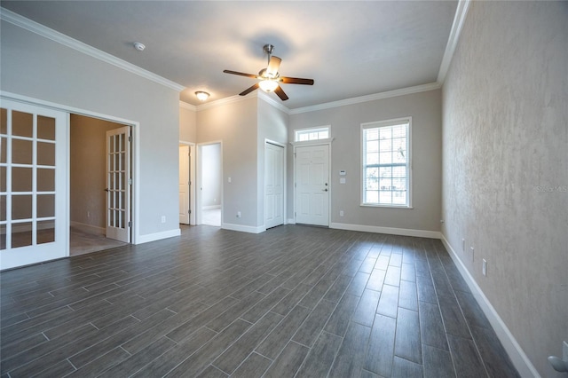 empty room with french doors, dark wood-type flooring, ornamental molding, a ceiling fan, and baseboards