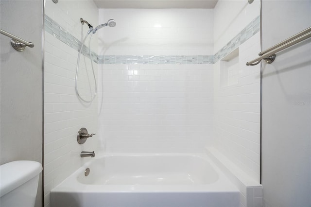 bathroom with toilet and washtub / shower combination