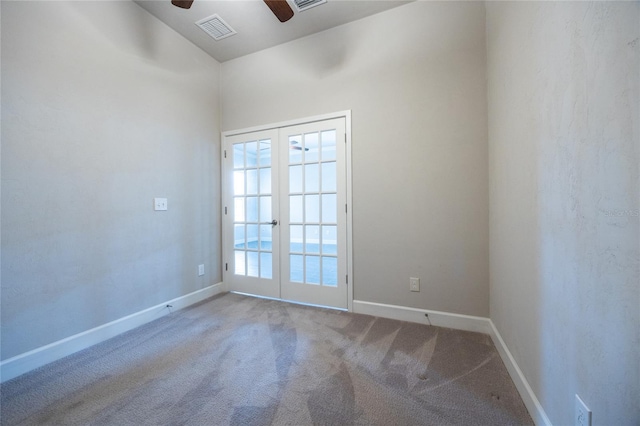 spare room featuring baseboards, visible vents, ceiling fan, carpet flooring, and french doors