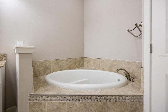 bathroom with a garden tub and vanity