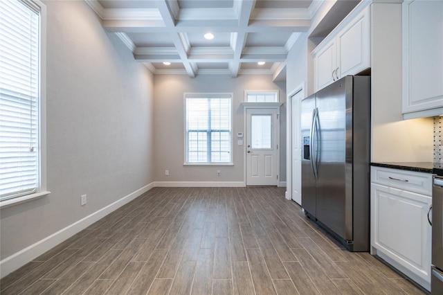 kitchen featuring baseboards, white cabinets, stainless steel fridge with ice dispenser, beamed ceiling, and wood finish floors