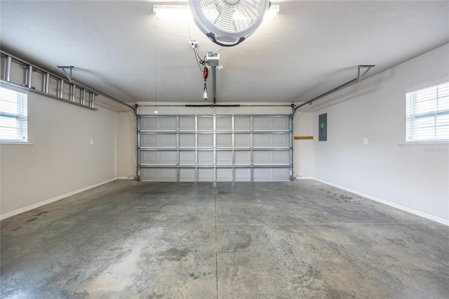 garage featuring electric panel and baseboards