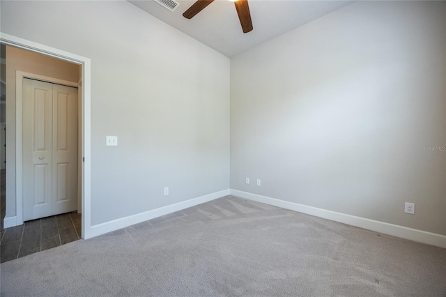 unfurnished room featuring baseboards, carpet flooring, ceiling fan, and vaulted ceiling