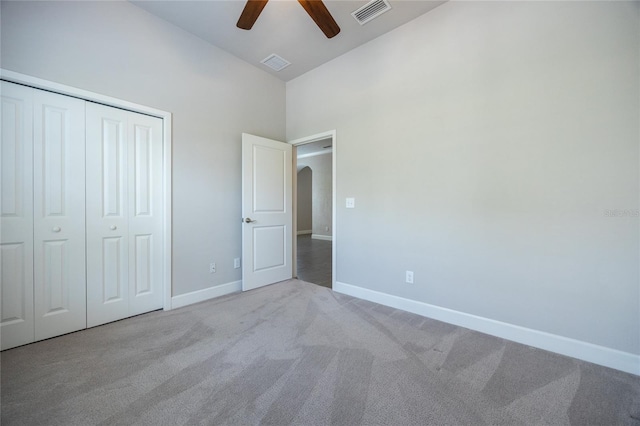 unfurnished bedroom featuring carpet flooring, high vaulted ceiling, visible vents, and baseboards
