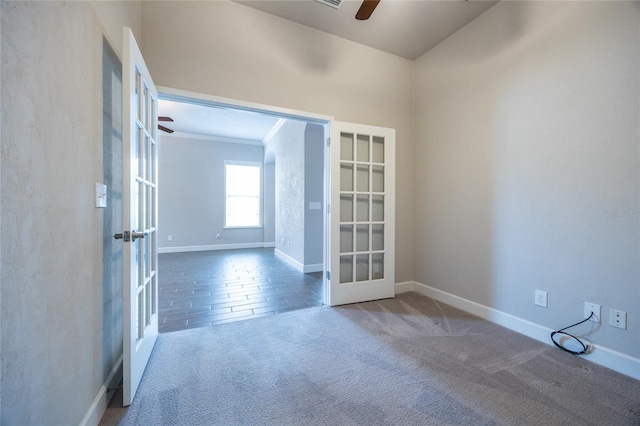 unfurnished room featuring french doors, carpet, ceiling fan, and baseboards