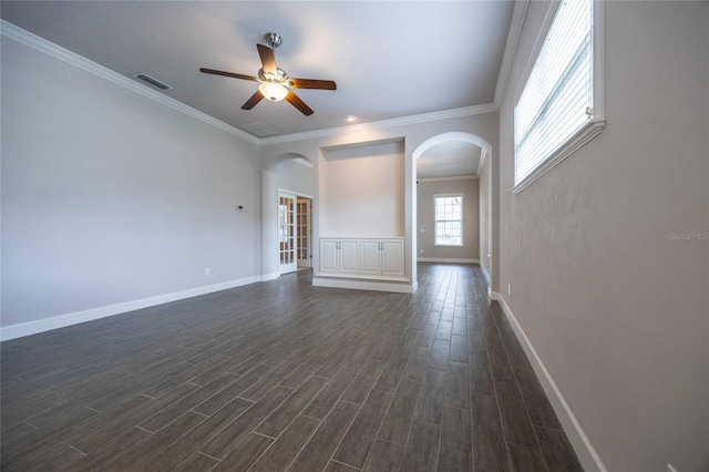 unfurnished living room with dark wood-style flooring, arched walkways, a ceiling fan, baseboards, and visible vents