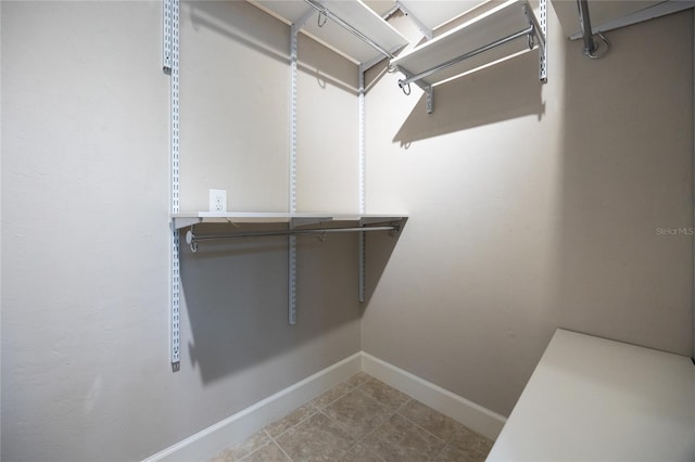 spacious closet featuring tile patterned flooring