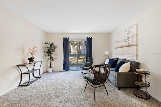 carpeted living area featuring baseboards