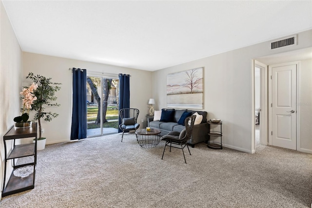 living area featuring carpet flooring, visible vents, and baseboards